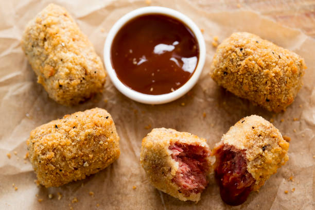 Crispy golden-brown croquettes with a dipping sauce